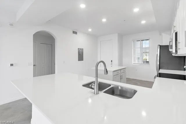 a lobby with furniture and chandelier