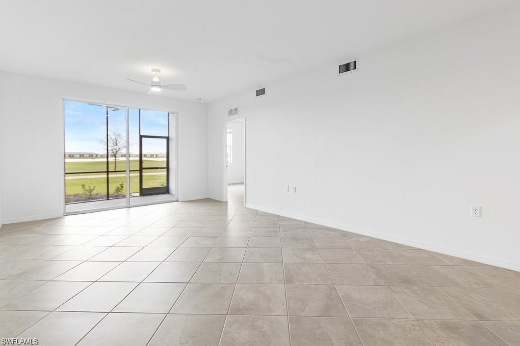 5651 Double Eagle Circle, Unit 4314 Immokalee, FL 34142 - Photo 5 of 41 Spare room featuring baseboards and light tile patterned flooring