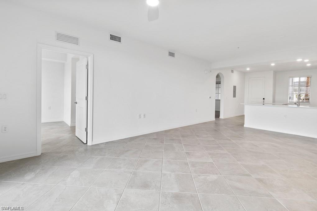 5651 Double Eagle Circle, Unit 4314 Immokalee, FL 34142 - Photo 6 of 41 Unfurnished living room featuring arched walkways, recessed lighting, light tile patterned floors, and a ceiling fan