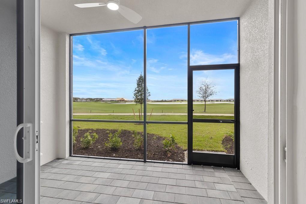 5651 Double Eagle Circle, Unit 4314 Immokalee, FL 34142 - Photo 7 of 41 Unfurnished sunroom featuring view of golf course and ceiling fan