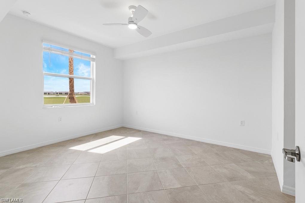 5651 Double Eagle Circle, Unit 4314 Immokalee, FL 34142 - Photo 8 of 41 Empty room featuring a ceiling fan and light tile patterned floors