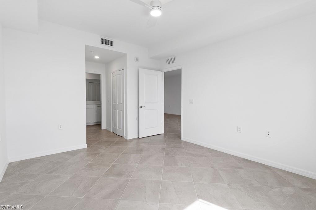 5651 Double Eagle Circle, Unit 4314 Immokalee, FL 34142 - Photo 9 of 41 Unfurnished bedroom with ceiling fan and connected bathroom