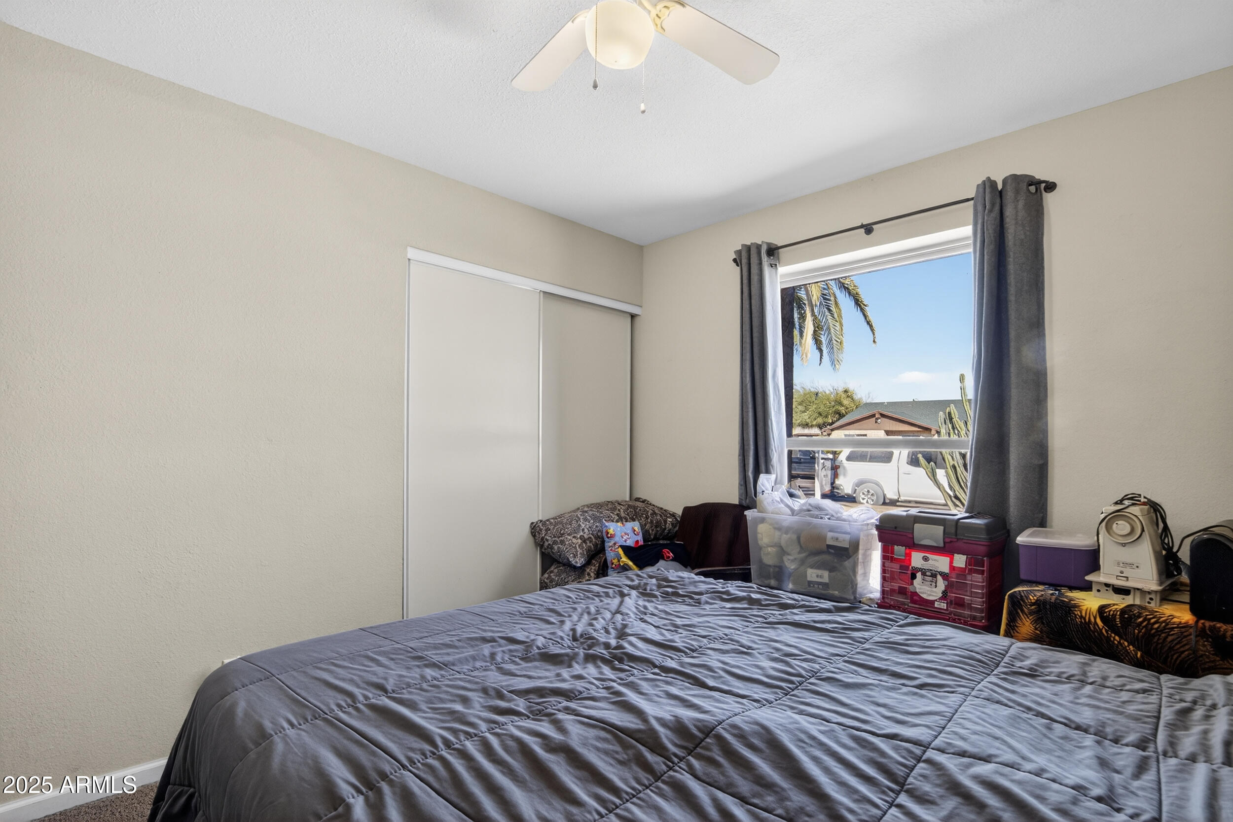 3939 West Cholla Street Phoenix, AZ 85029 - Photo 5 of 11 a bedroom with a bed and a chandelier