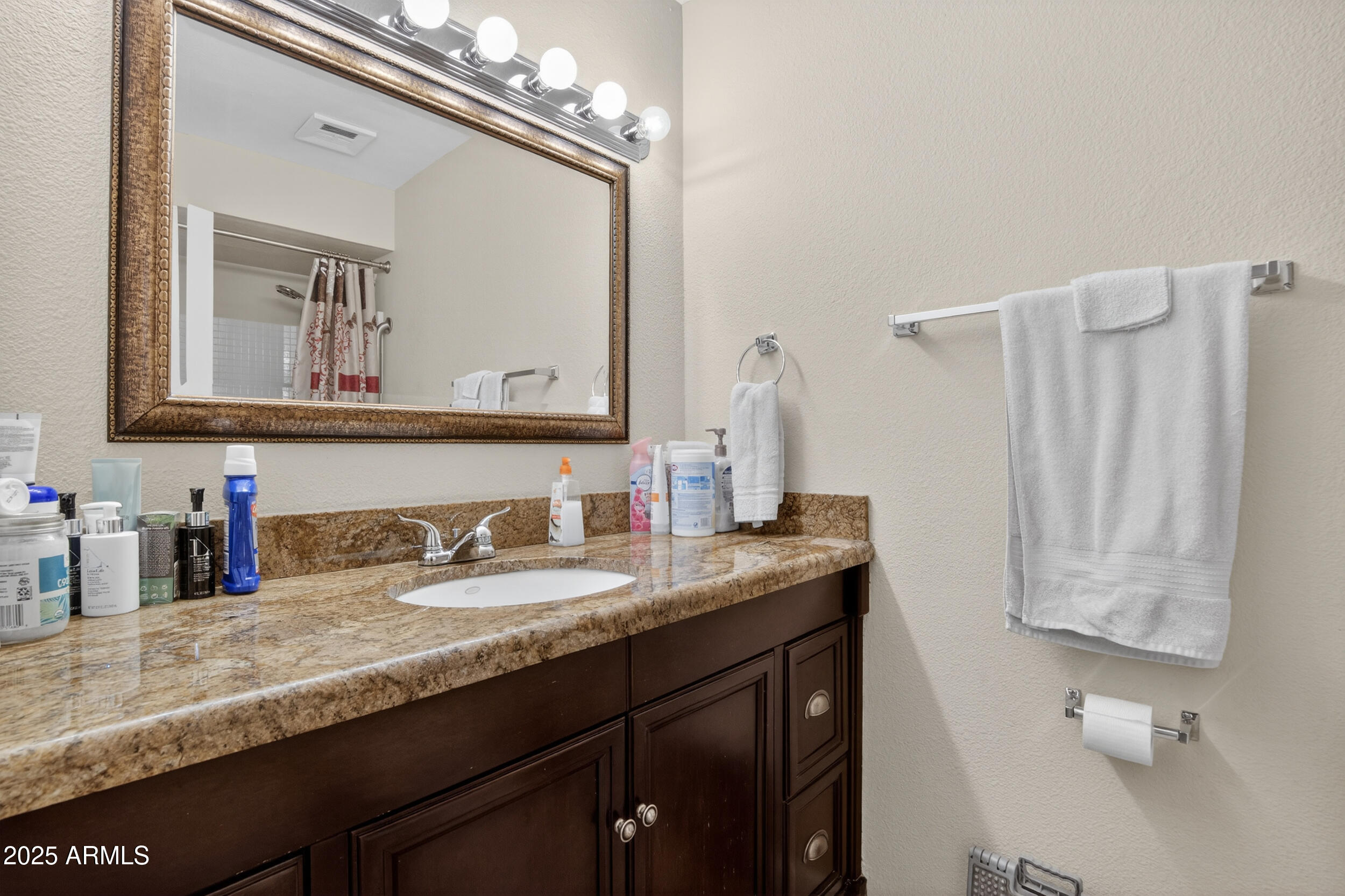 3939 West Cholla Street Phoenix, AZ 85029 - Photo 6 of 11 a bathroom with a granite countertop sink and a mirror