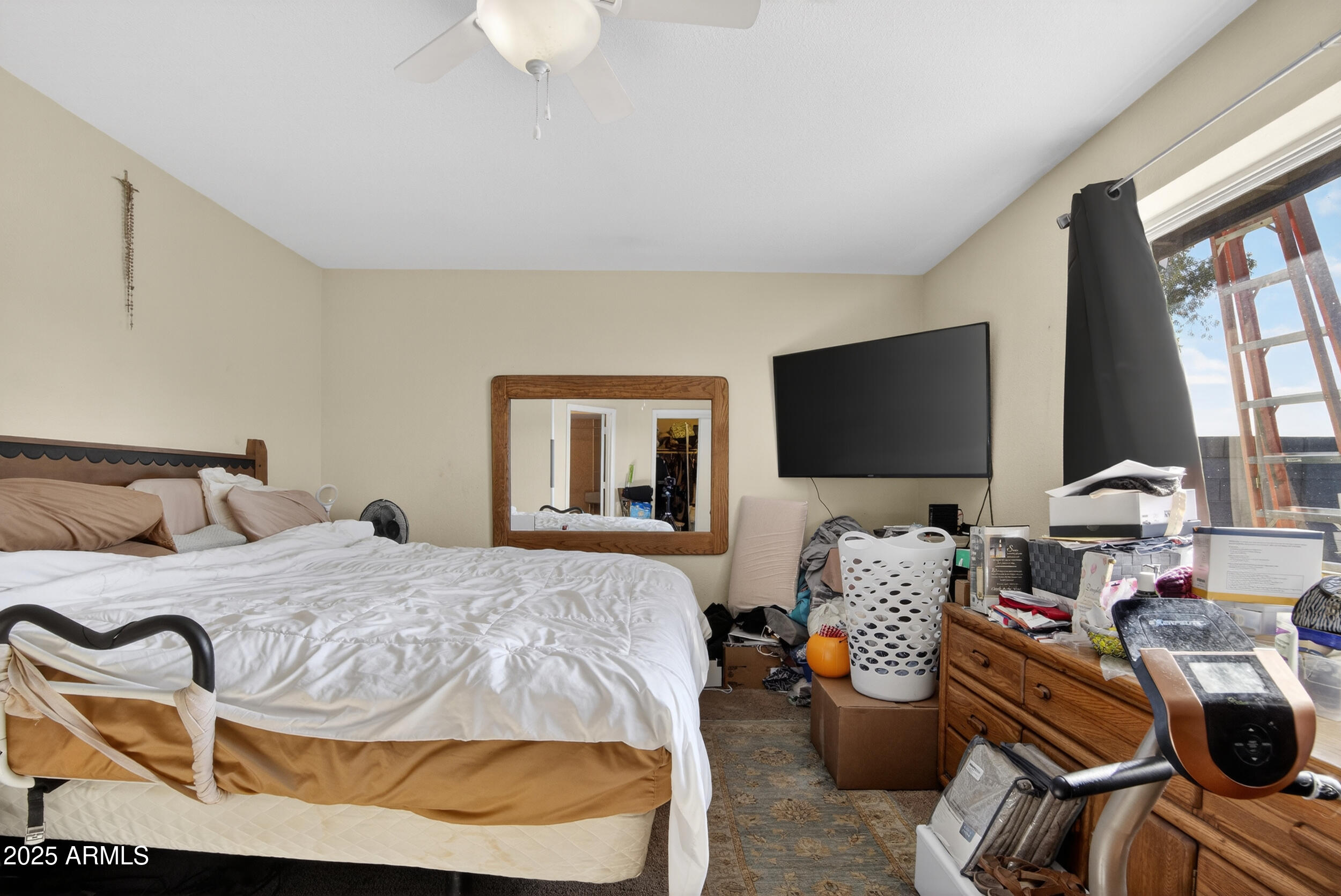 3939 West Cholla Street Phoenix, AZ 85029 - Photo 7 of 11 a bedroom with a bed and flat screen tv