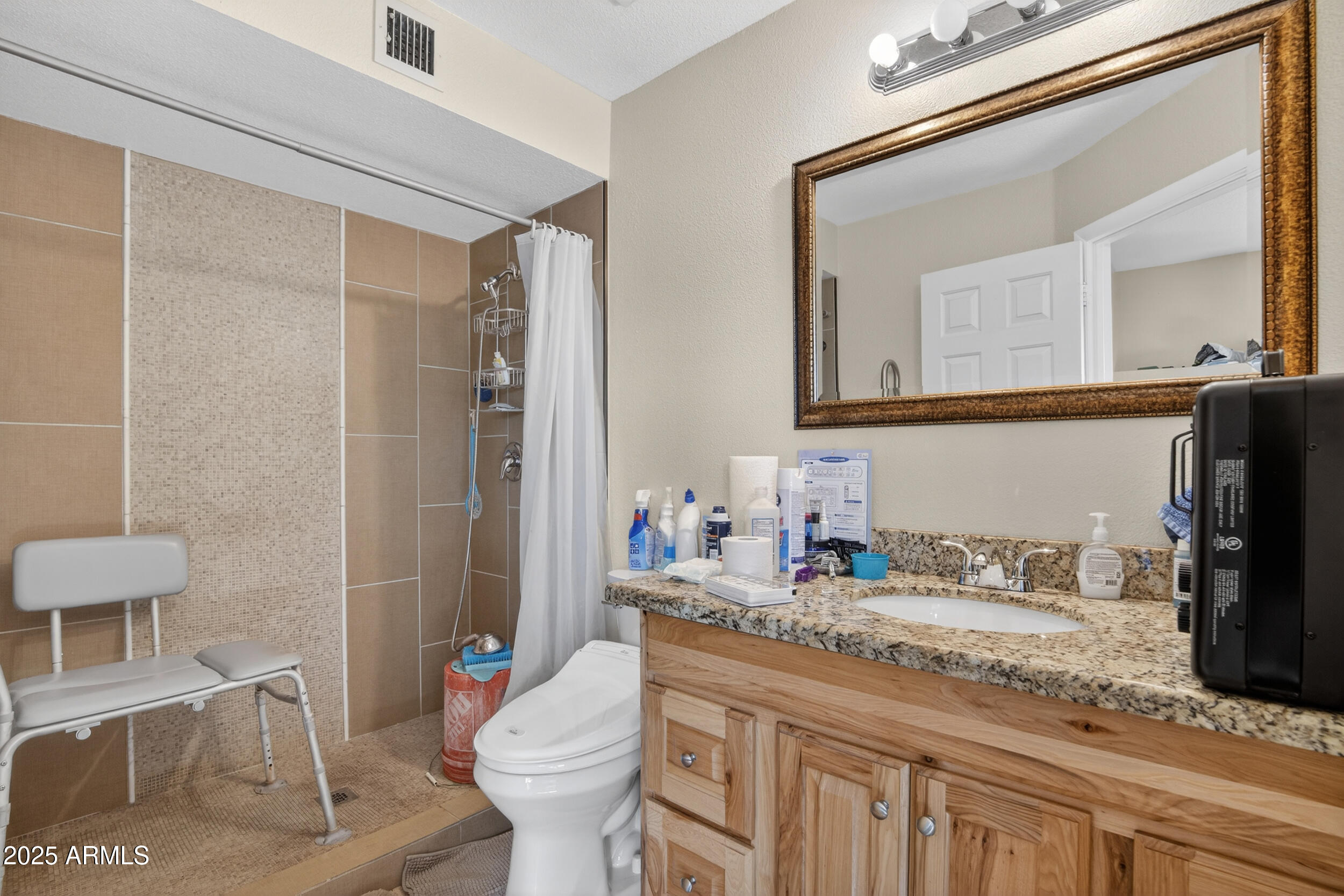 3939 West Cholla Street Phoenix, AZ 85029 - Photo 8 of 11 a bathroom with a granite countertop sink mirror vanity and toilet