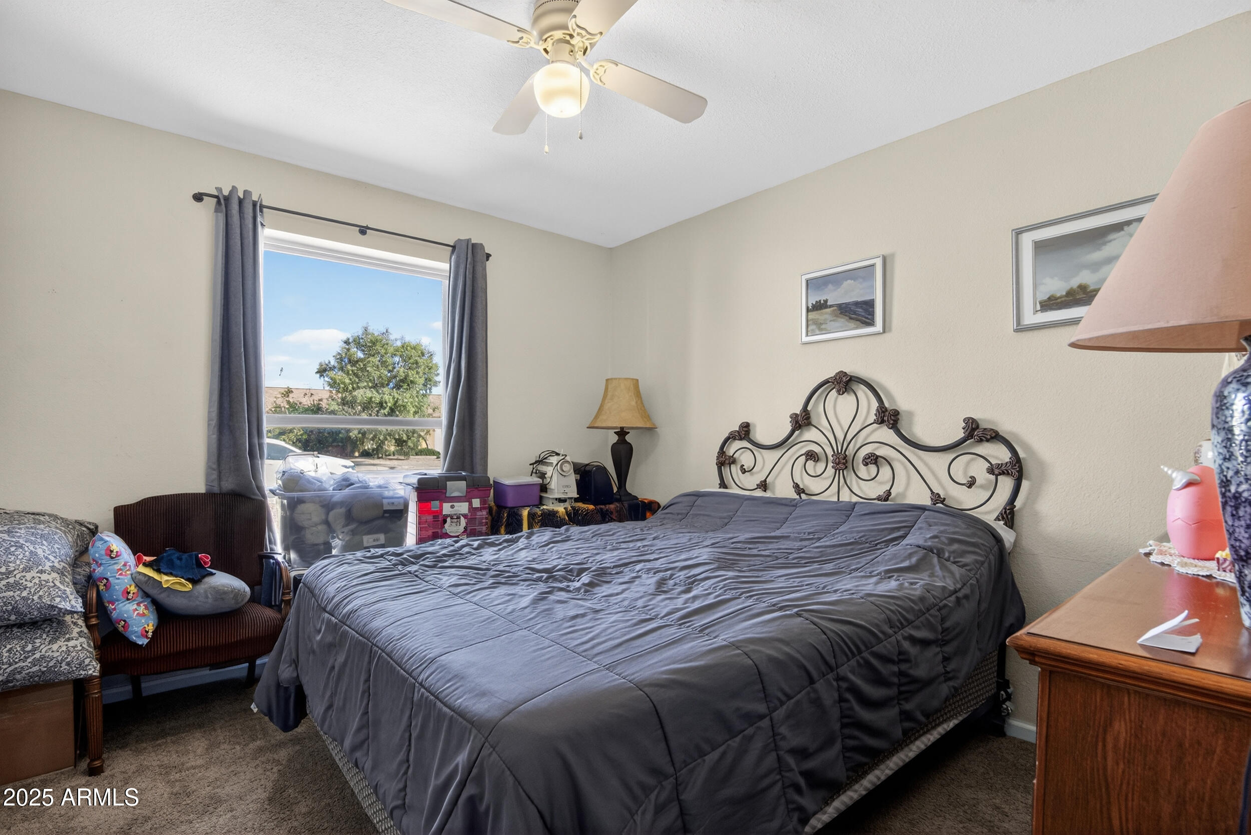 3939 West Cholla Street Phoenix, AZ 85029 - Photo 9 of 11 a bedroom with a bed and wooden floor