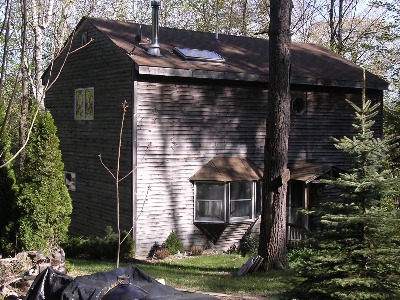 143-151 Rainbow Road Otis, MA 01029 - Photo 2 of 18 a front view of a house with garden
