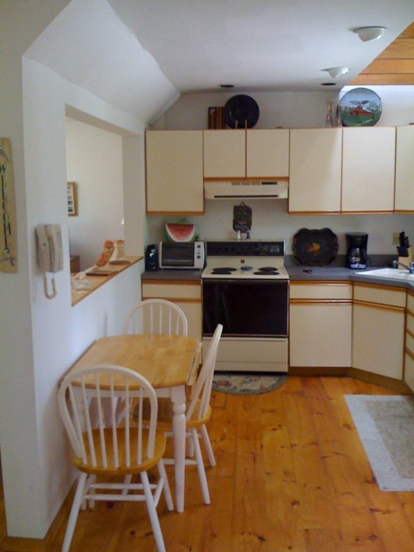 143-151 Rainbow Road Otis, MA 01029 - Photo 15 of 18 a kitchen with stainless steel appliances granite countertop a stove a sink dishwasher and cabinets with wooden floor