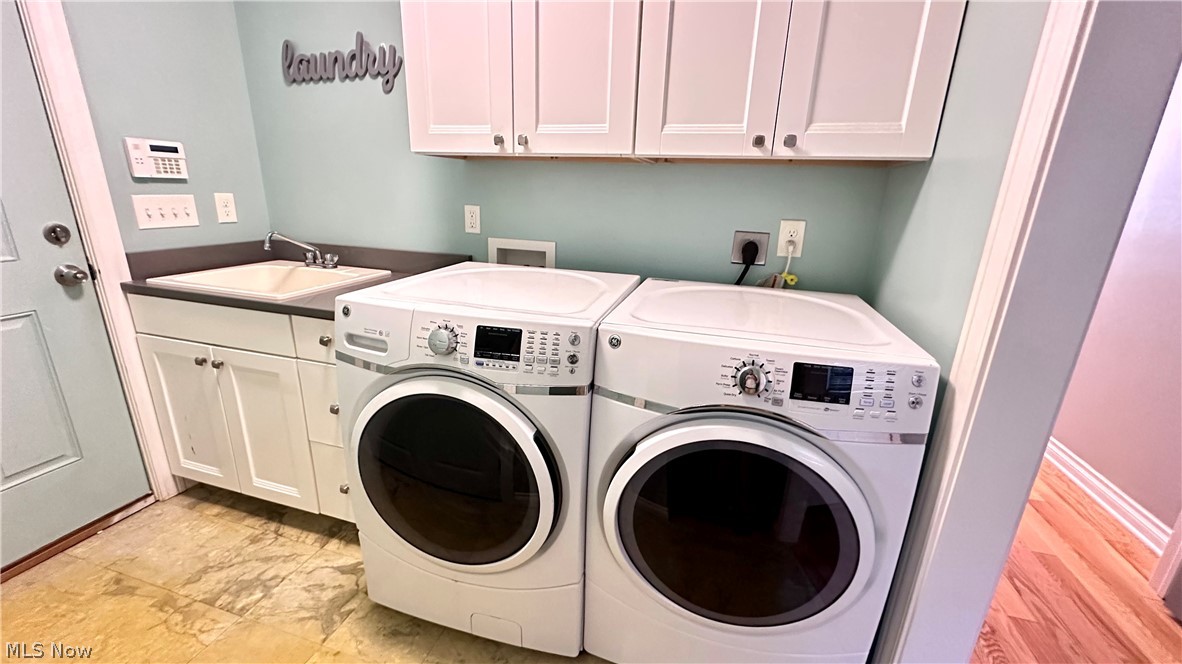 2603 Rockefeller Road Wickliffe, OH 44092 - Photo 25 of 34 Dedicated laundry area featuring white upper and lower cabinetry, a utility sink, and durable flooring
