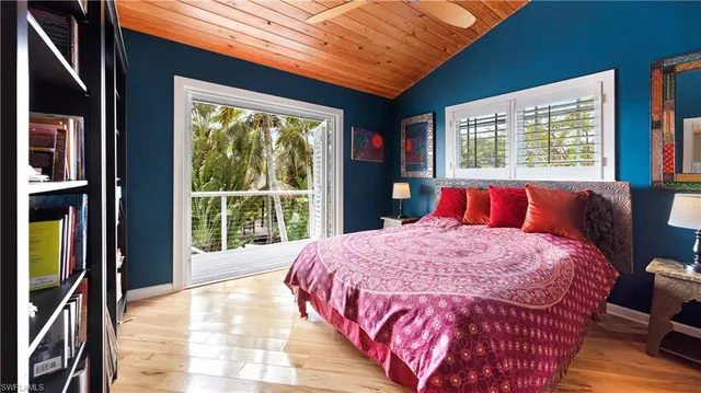 a bed sitting in a bedroom next to a window