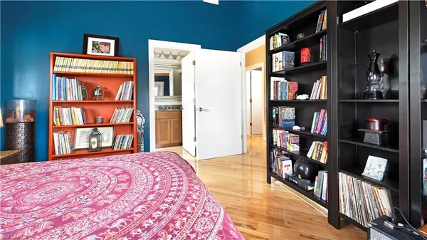 a bedroom with a bed and a book shelf
