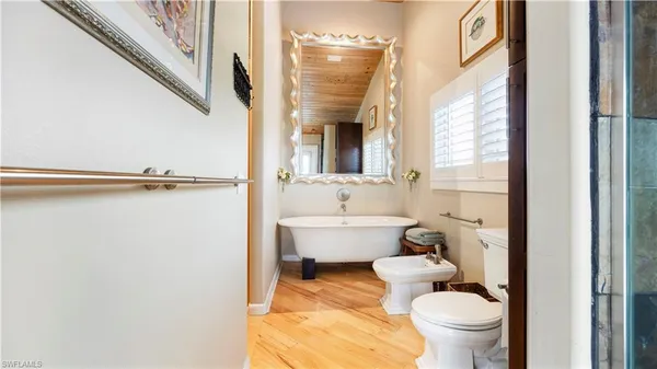 a bathroom with a toilet a sink and a mirror