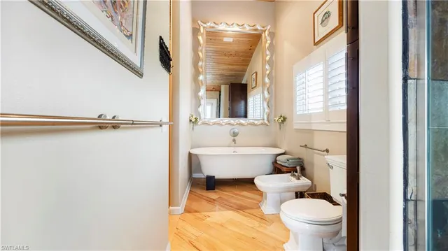 a bathroom with a toilet a sink and a mirror