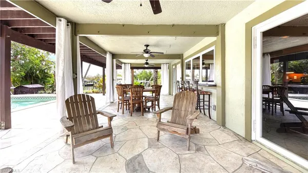 a dining room with furniture water view and a floor to ceiling window
