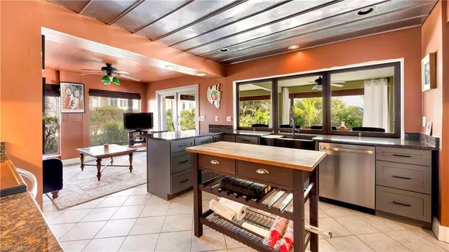 a kitchen with a sink and chairs