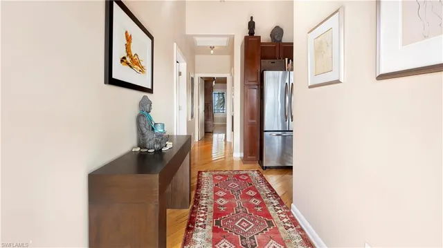 a hallway with table and potted plant