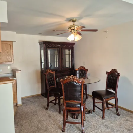 a view of a dining room with furniture and a chandelier