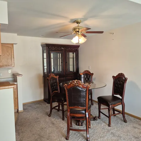 a view of a dining room with furniture and a chandelier