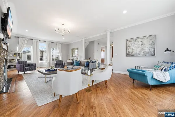 a living room with fireplace furniture and a wooden floor