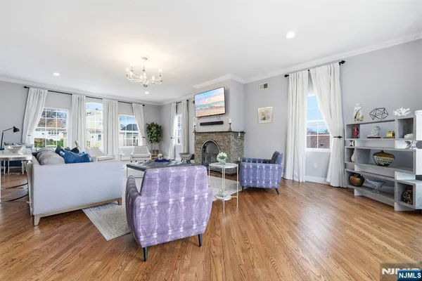 a living room with furniture wooden floor and a fireplace