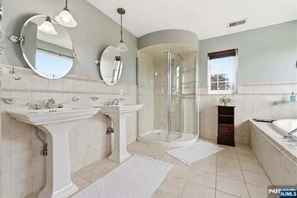 a spacious bathroom with a sink a mirror and a shower