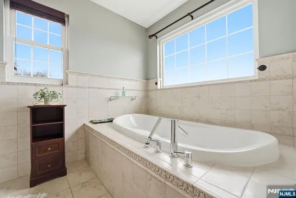 a white bath tub sitting in a bathroom