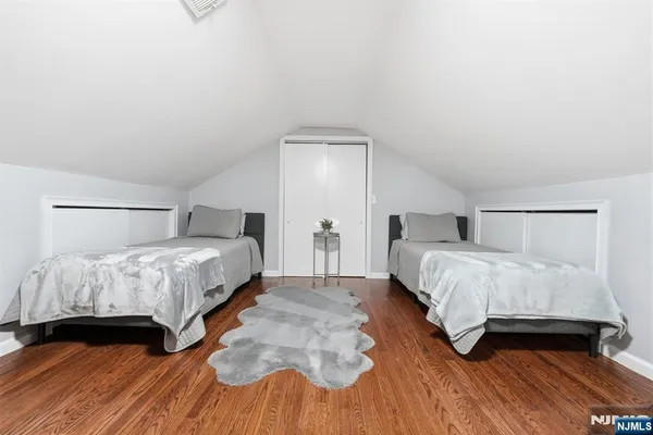 a bedroom with a bed and a night stand