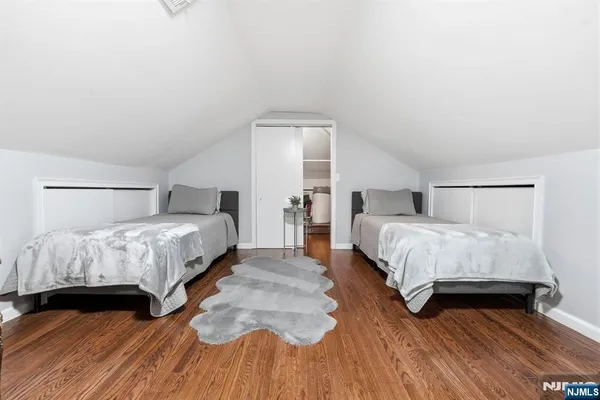 a bedroom with a bed and a wooden floor