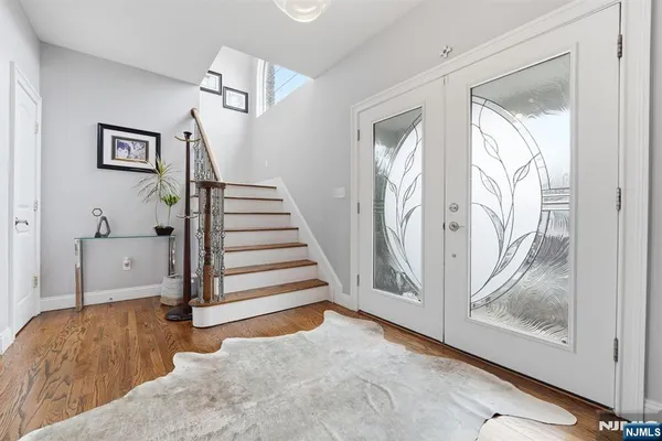 a view of a livingroom with wooden floor and stairs