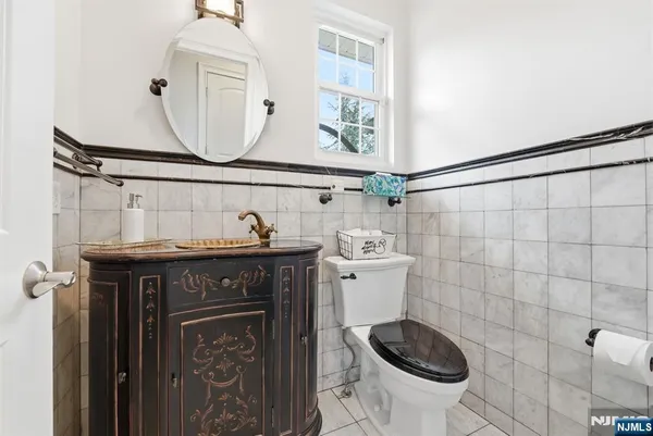 a bathroom with a sink a toilet and a mirror