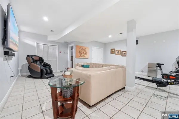 a living room with furniture a flat screen tv and a table