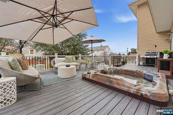a view of a rooftop deck with couch and chairs