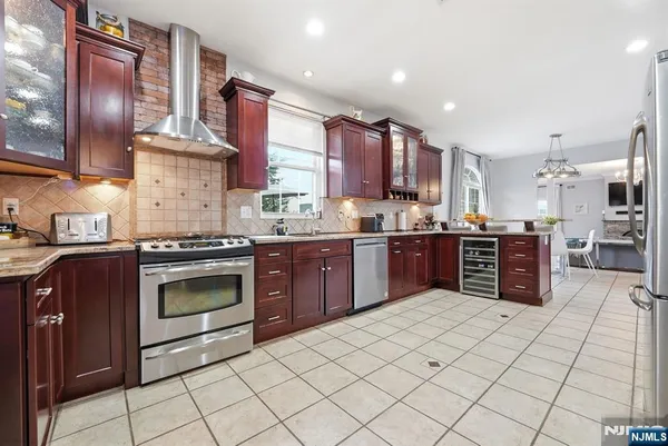 a kitchen with stainless steel appliances granite countertop a stove sink and cabinets