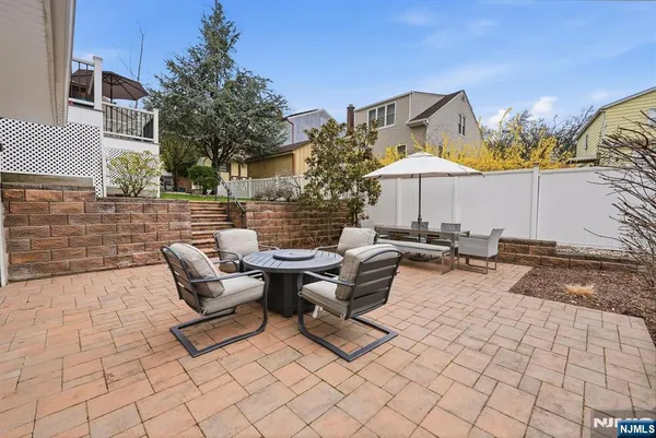 a view of a backyard with table and chairs under an umbrella