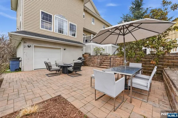 an aerial view of a house with garden space and street view