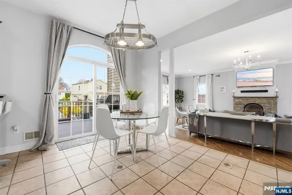 a living room with furniture a dining table and a chandelier