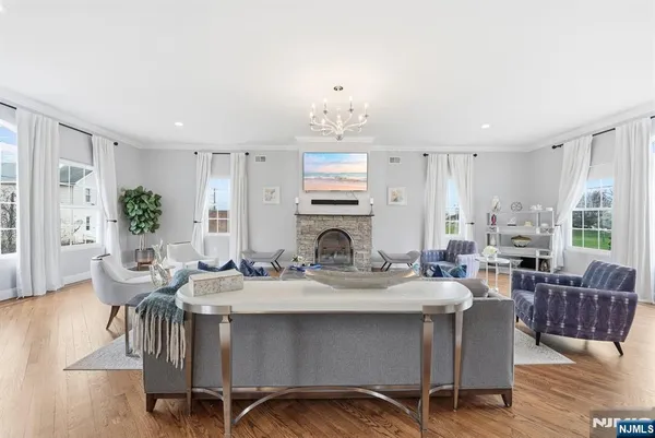 a view of a a dining room with furniture window and wooden floor