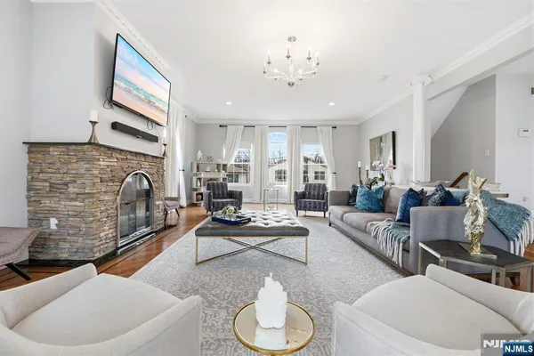 a living room with furniture a fireplace and a flat screen tv