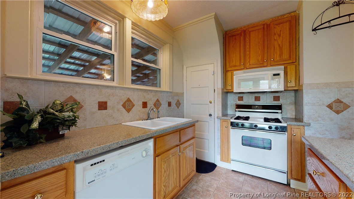 1913 Morganton Road Fayetteville, NC 28305 - Photo 26 of 45 a kitchen with a sink stove and cabinets