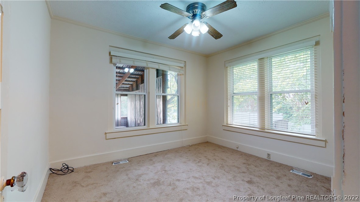 1913 Morganton Road Fayetteville, NC 28305 - Photo 30 of 45 an empty room with a window and ceiling fan