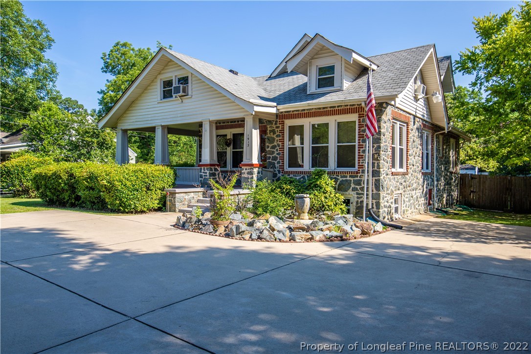 1913 Morganton Road Fayetteville, NC 28305 - Photo 5 of 45 a front view of a house with a yard and potted plants