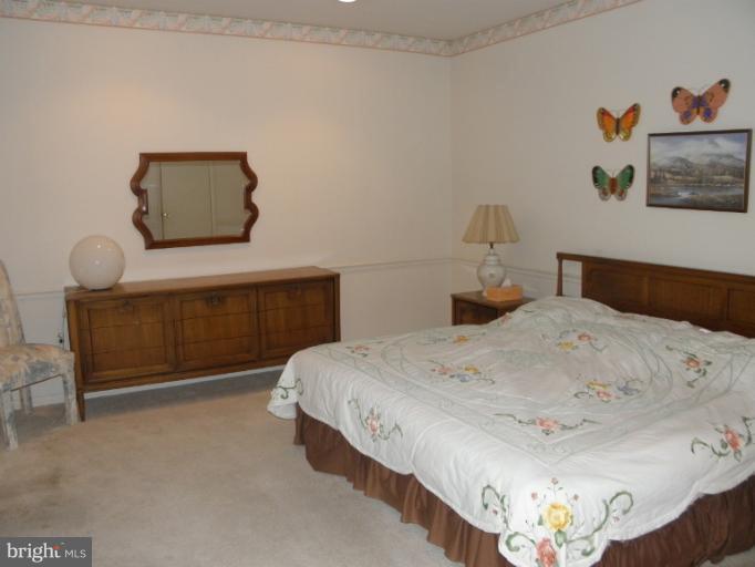 3031 Fallstaff Road, Unit 607C Baltimore, MD 21209 - Photo 11 of 14 a bedroom with a bed and dresser