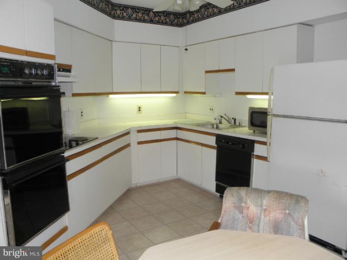 3031 Fallstaff Road, Unit 607C Baltimore, MD 21209 - Photo 12 of 14 a kitchen with a sink appliances and cabinets