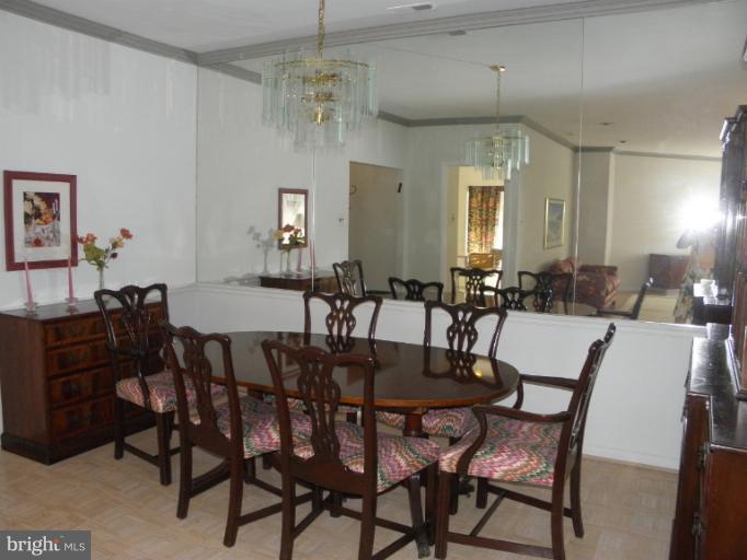 3031 Fallstaff Road, Unit 607C Baltimore, MD 21209 - Photo 4 of 14 a view of a dining room with furniture and chandelier