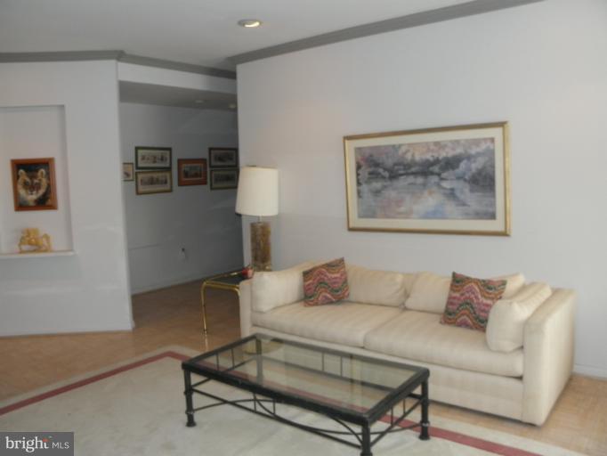 3031 Fallstaff Road, Unit 607C Baltimore, MD 21209 - Photo 6 of 14 a living room with furniture and a lamp