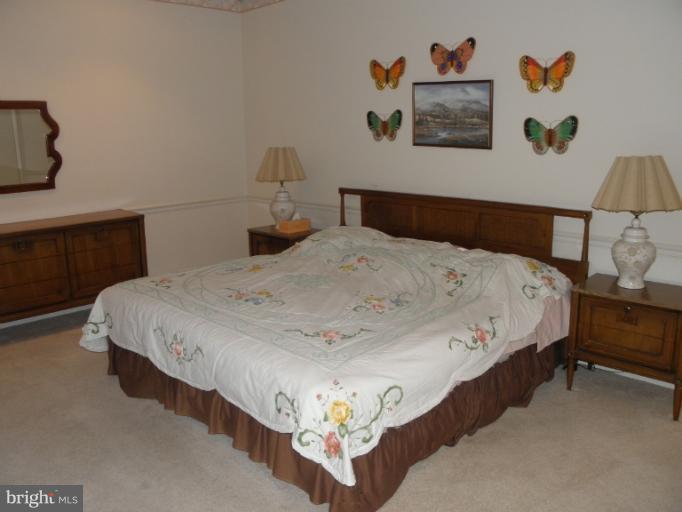 3031 Fallstaff Road, Unit 607C Baltimore, MD 21209 - Photo 10 of 14 a bedroom with a bed and wall painting