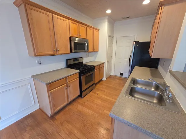 a backyard of a house with table and chairs