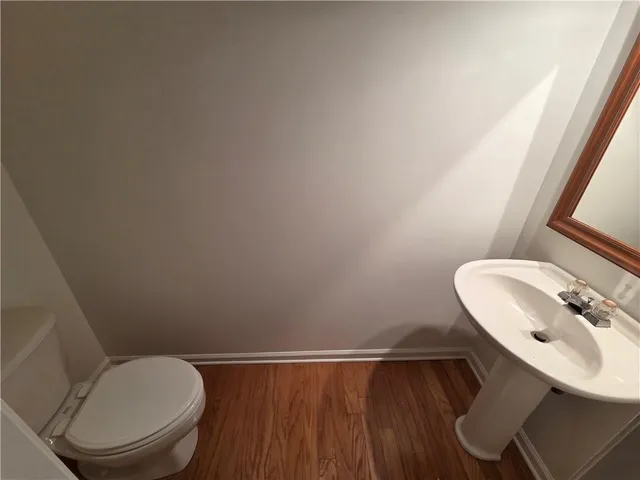a bathroom with a toilet a sink and a mirror