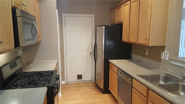 a kitchen with a refrigerator stove and sink